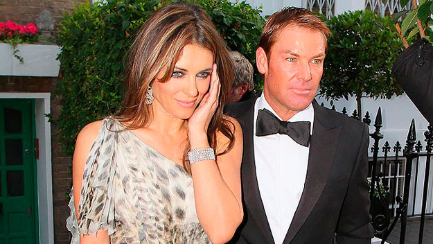  Shane Warne, Liz Hurley display their matching looks at NY airport