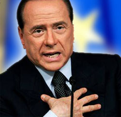 Recovering Berlusconi bites into ‘out-sized breasts’ cake with blonde MP!